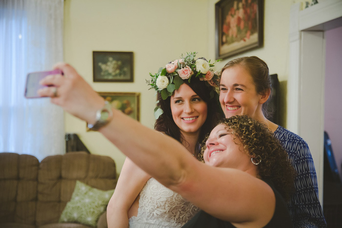 bride taking selfie with friends