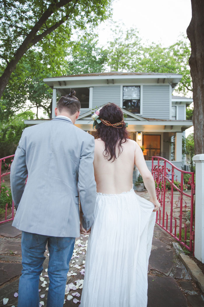 bride and groom walking back to house