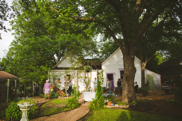 family setting up backyard wedding