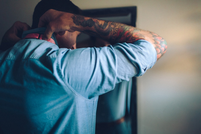 groom adjusting collar 