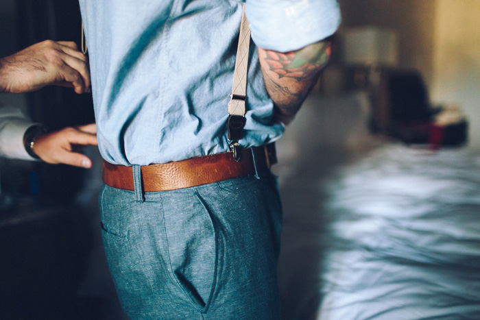 groom tucking in shirt