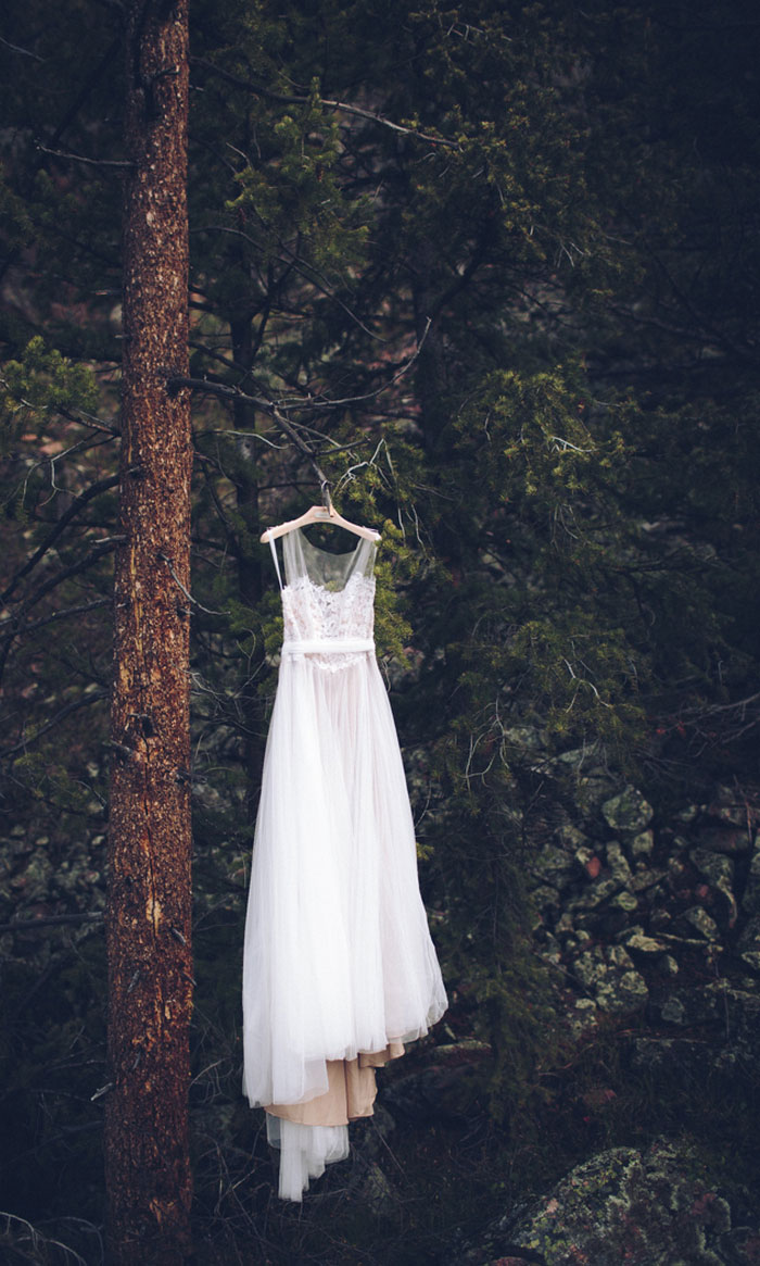 wedding dress hanging in the woods