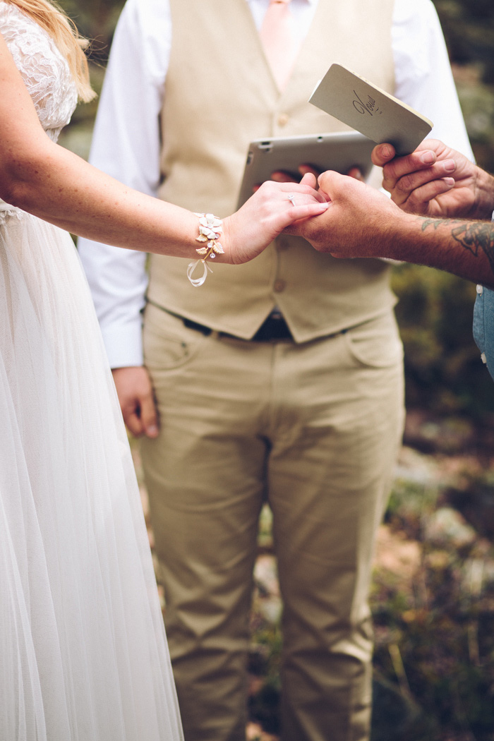 bride and groom holding hands during ceremony