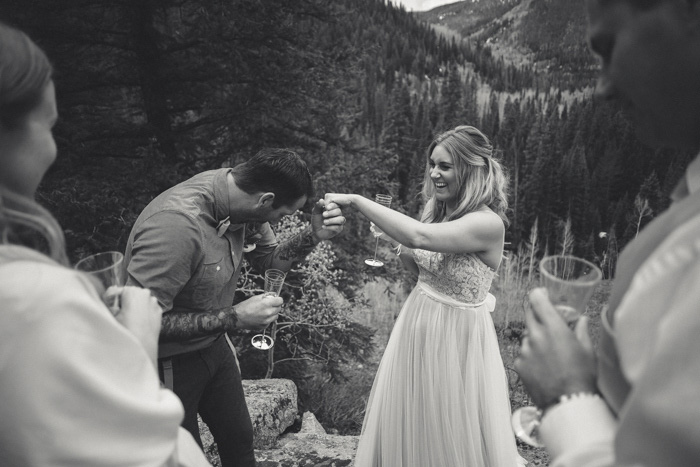 bride and groom celebrating on mountainside