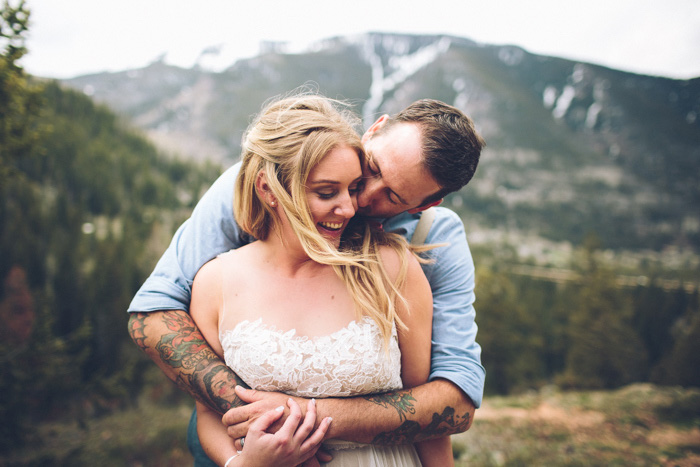 groom embracing bride from behind