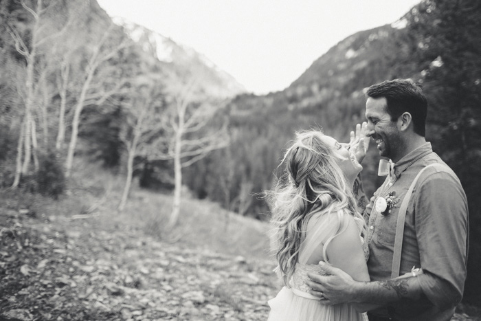 bride and groom dancing on mountainside