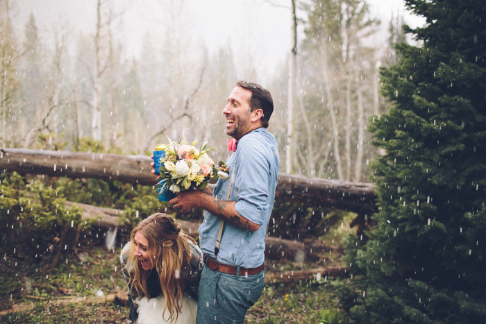 bride and groom getting rained on