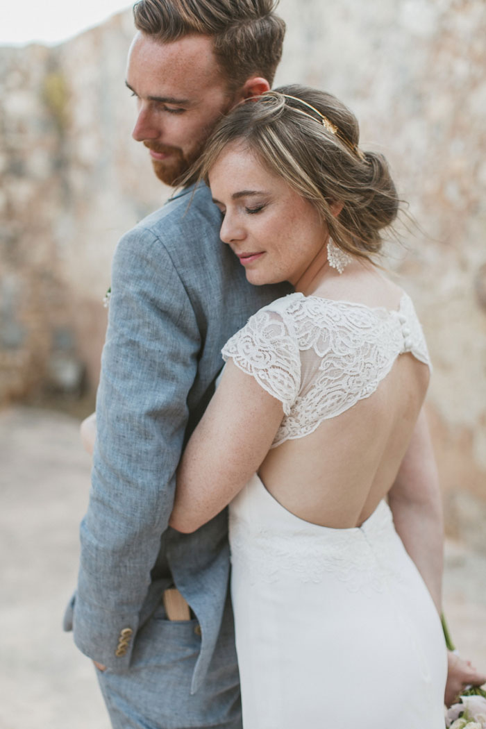 bride embracing groom from behind