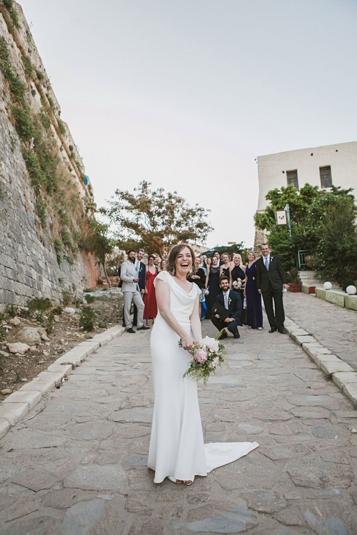 bride getting ready to toss bouquet