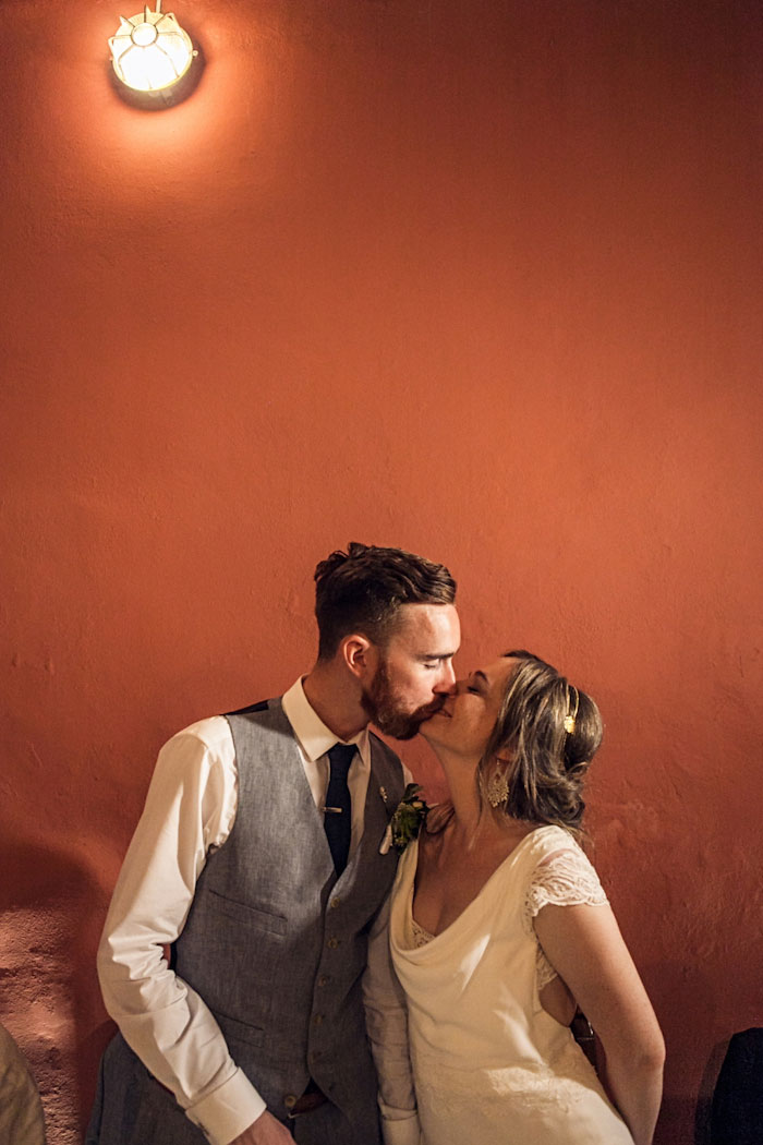 bride and groom kissing at reception