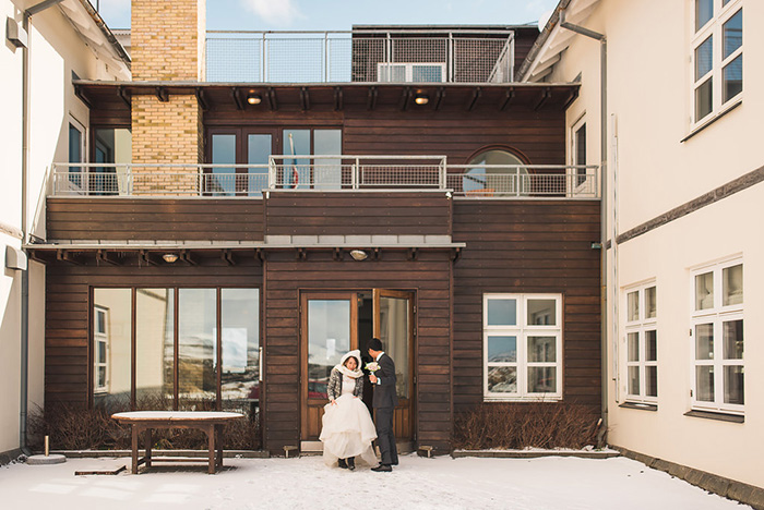 bride and groom in front of Iceland hotel