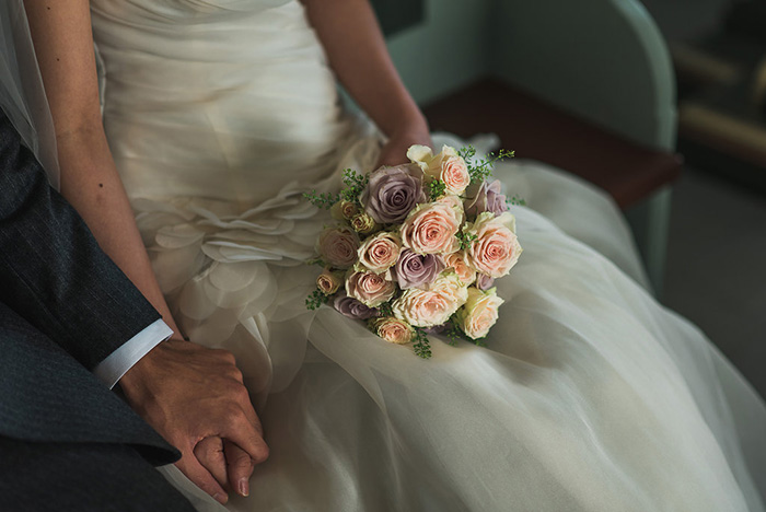 bride with bouquet in lap