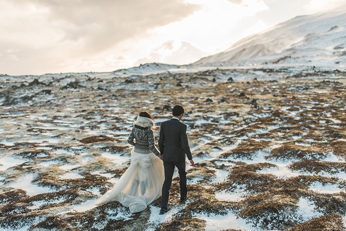 bride and groom walking in Iceland