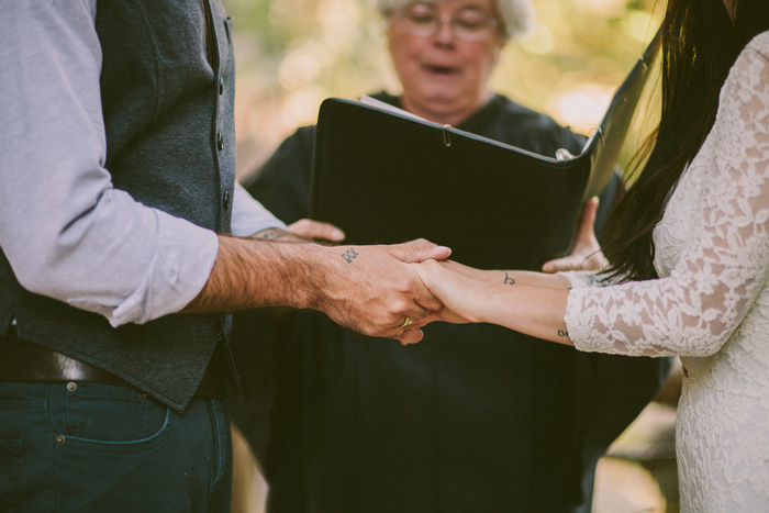 bride and groom holding hands during elopement ceremony