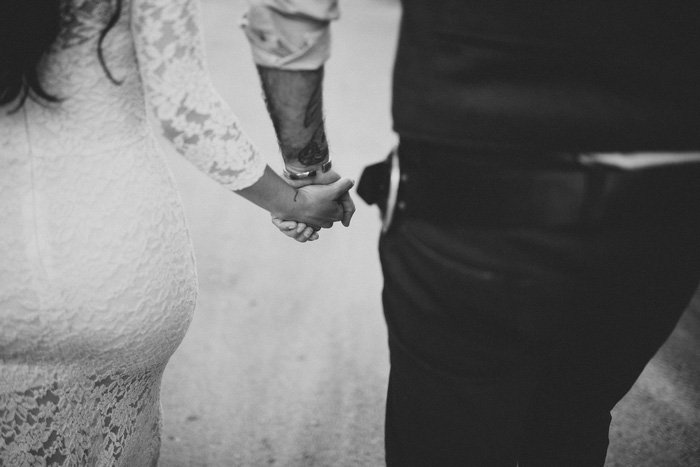 bride and groom holding hands