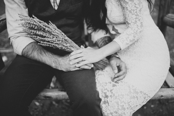 bride and groom sitting on bench