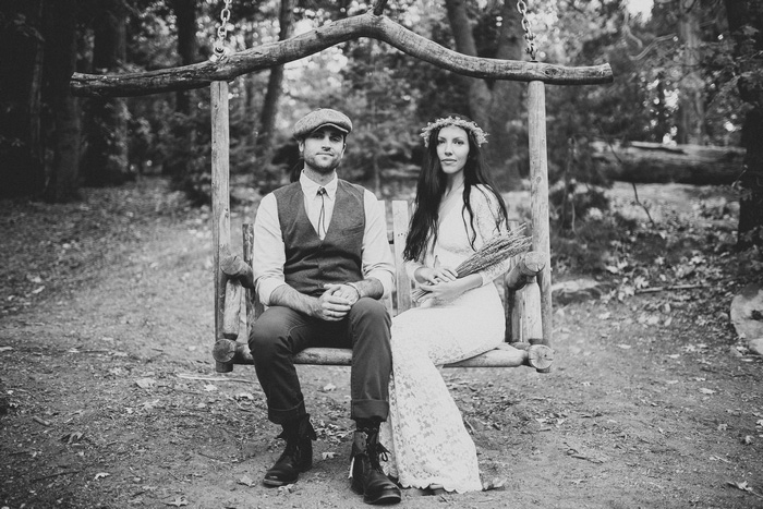 bride and groom sitting on swing