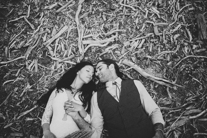 bride and groom lying on the ground