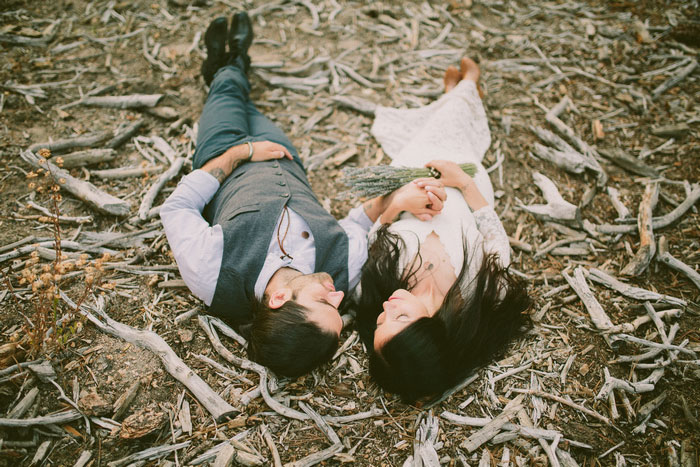 bride and groom portrait lying on the ground