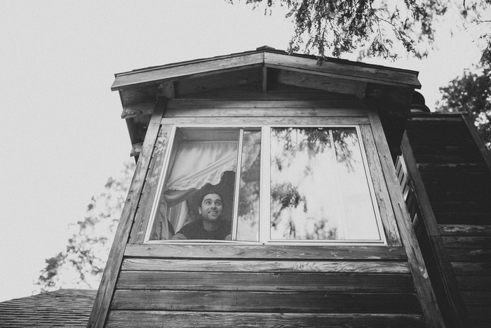 groom looking out cabin window