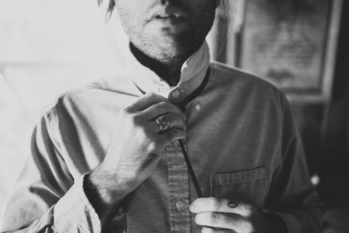 groom tying tie