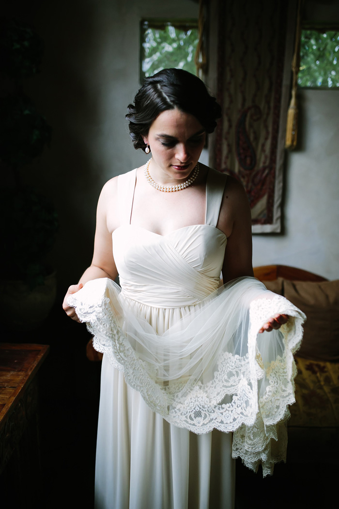 bride holding lace trimmed veil