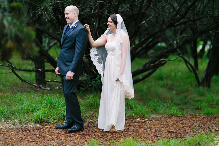 bride tapping groom on shoulder