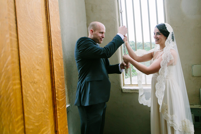 bride and groom ringing church bell