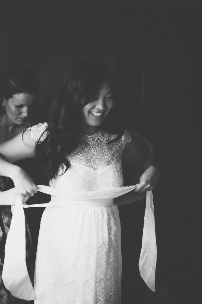 bride putting her sash on