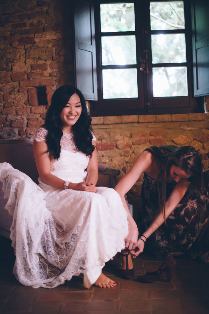 bride getting her shoes buckled