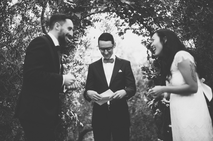 bride and groom laughing at the altar