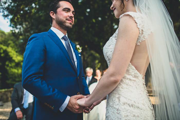 bride and groom holding hands during ceremony 