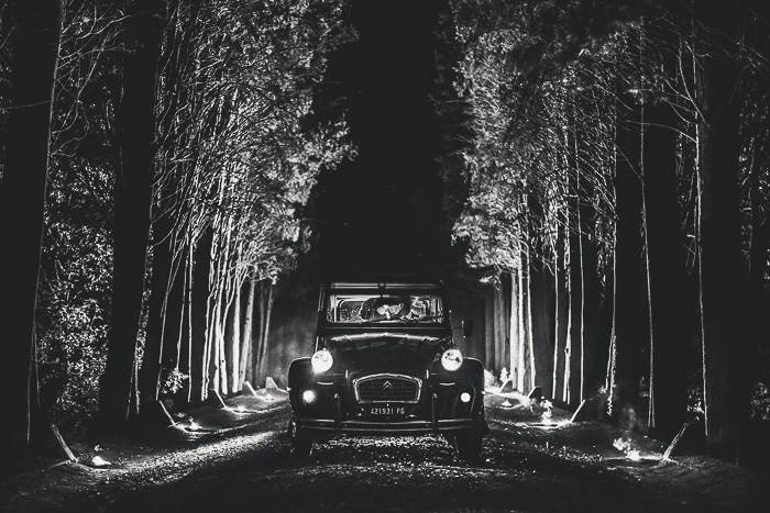 bride and groom in vintage getaway car