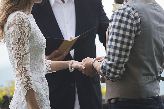 groom putting ring on bride's finger