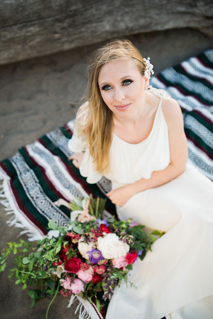 bride on beach blanket