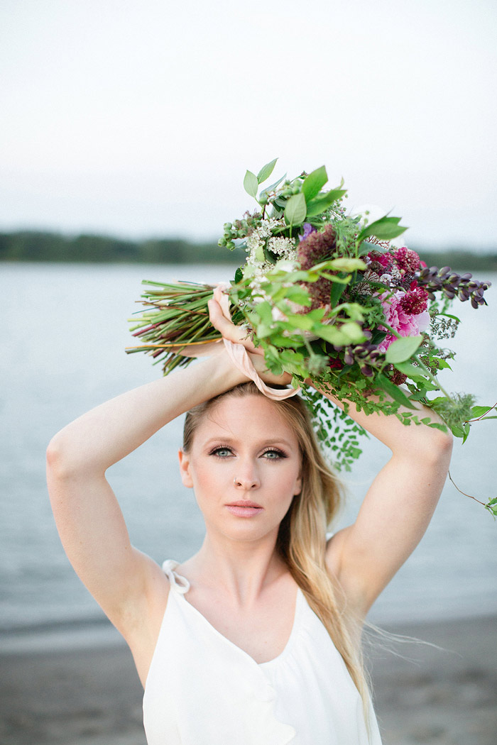 bride holding bouquet over her head