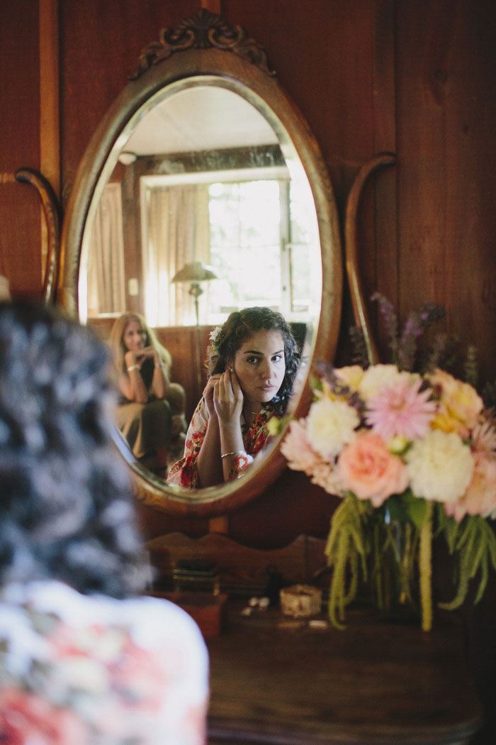 bride putting on earrings