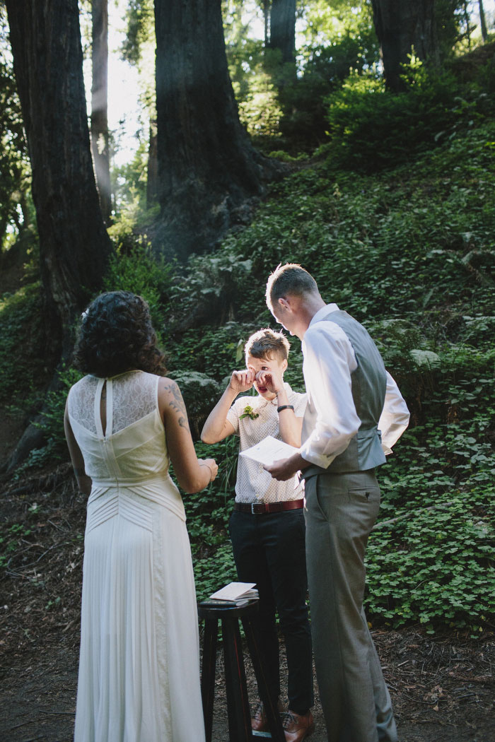 bride wiping away tears during ceremony 