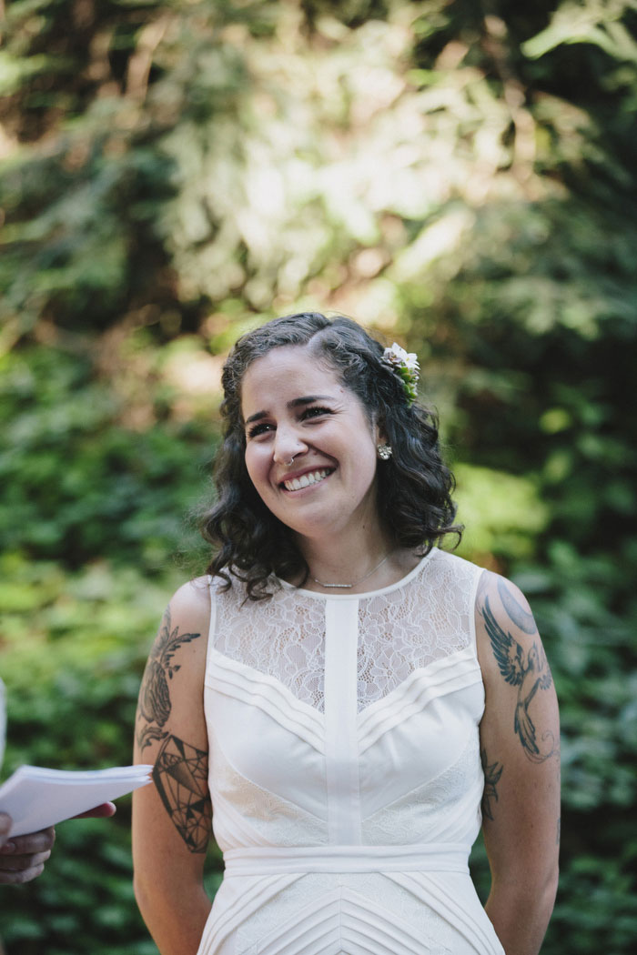 bride smiling at her bride during ceremony 