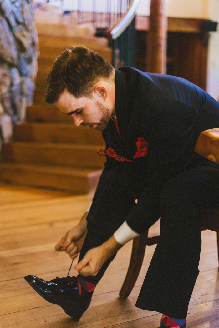 groom tying shoe