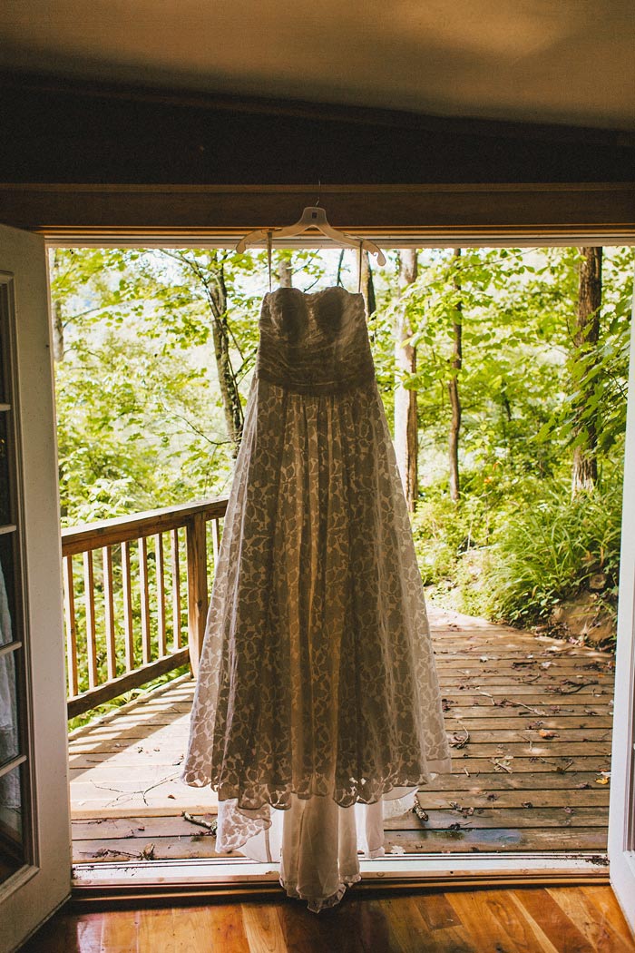 wedding dress hanging up on doorway