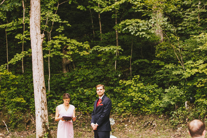 groom watching his bride walk down the aisle 