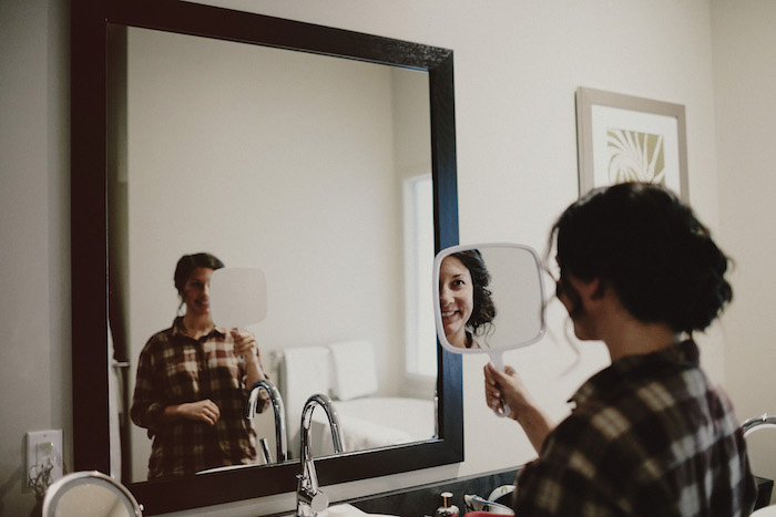 bride looking at her reflection 