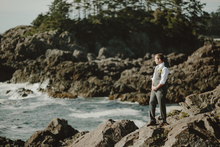 groom waiting by the ocean for his bride