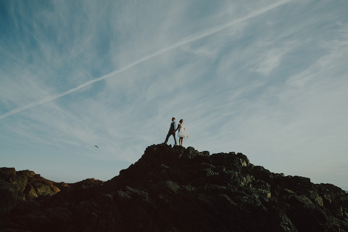 bride and groom portrait atop rocks