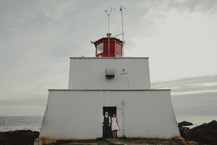 bride and groom portrait in front of lighthouse