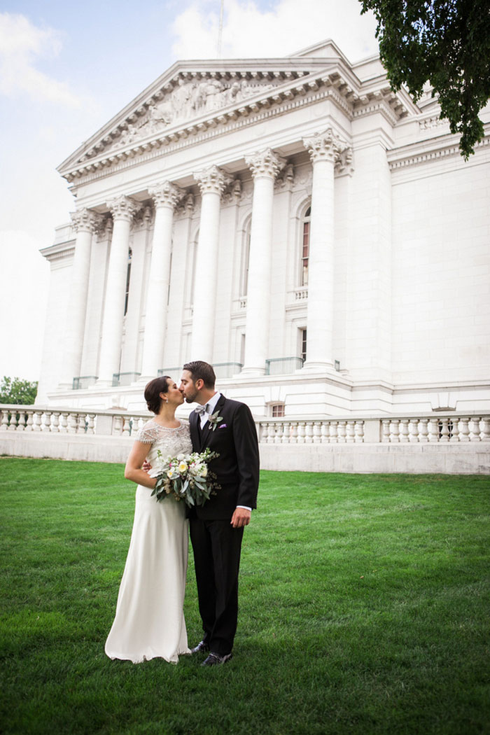 bride and groom kissing on lawn