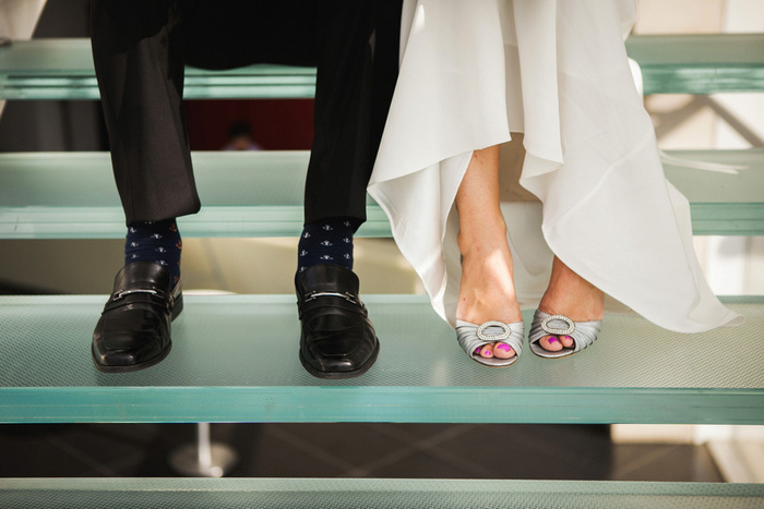 bride and groom's feet on glass stairs