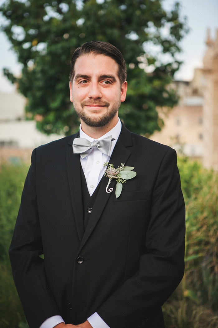 groom watching his bride walk down the aisle