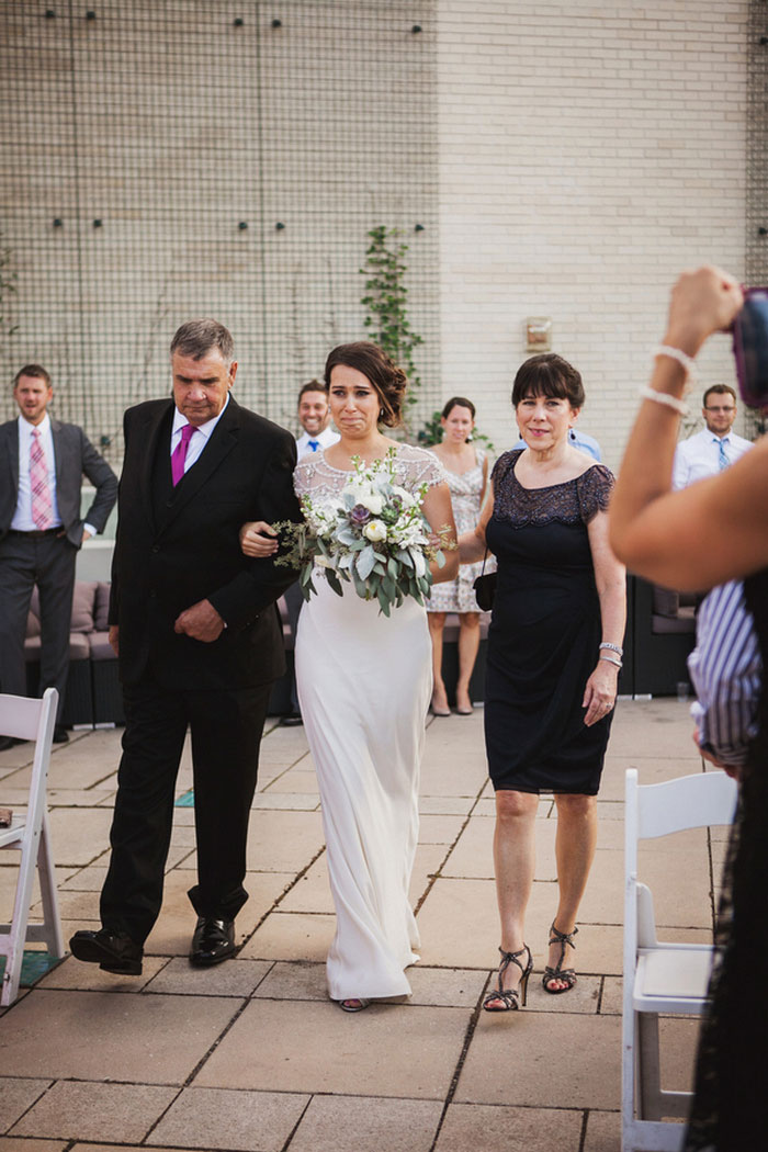 bride walking down the aisle with her parents